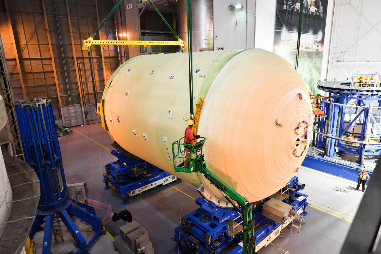 The Space Launch System (SLS) rocket’s liquid oxygen tank structural test article was manufactured and stacked in June 2019 at NASA’s Michoud Assembly Facility in New Orleans. To construct the test article, Boeing technicians at Michoud moved the liquid oxygen tank to the Vertical Assemby Building stacking and integration area. Here, they added simulators to mimic the two structures that connect to the tank, the intertank and the forward skirt.  This structural hardware for the SLS core stage for America’s new deep space rocket is structurally identical to the flight version of the tank. It will be shipped on the Pegasus barge to NASA’s Marshall Space Flight Center in Hunstville, Alabama, where it will undergo a series of tests that simulate the stresses and loads of liftoff and flight. These tests will help ensure designs are adequate for successful SLS missions to the Moon and beyond. The flight liquid oxygen tank along with the liquid hydrogen tank supplies more than 500,000 gallons of propellant to the core stages four RS-25 engines, which produce 2 million pounds of thrust to help send the SLS rocket to space.